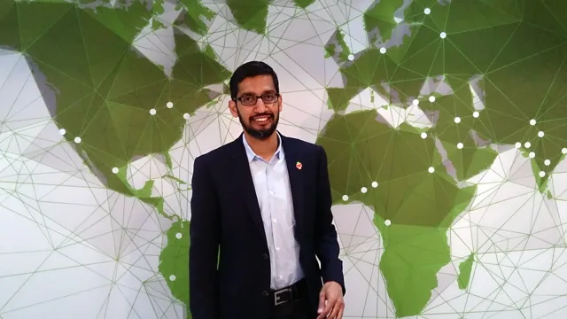 Google CEO Sundar Pichai standing in front of a green network-map backdrop. Photo by Maurizio Pesce, CC BY 2.0, via Wikimedia Commons.